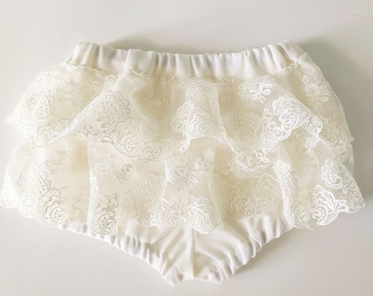 a close up of a white panties on a white surface with an object in the background