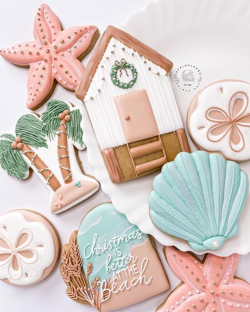 decorated cookies are laid out on a white surface with the words christmas is better at the beach