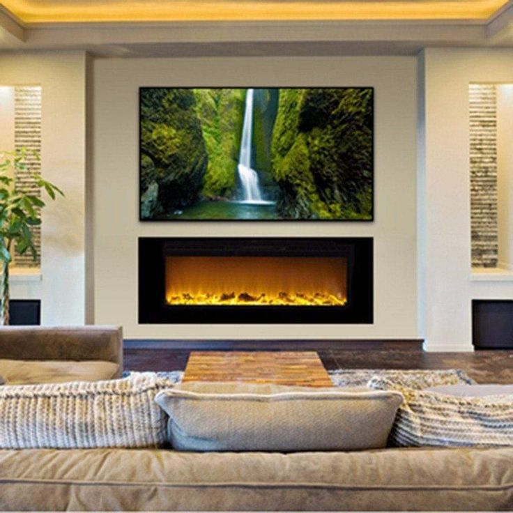 a living room with couches and a large television mounted to the wall above it