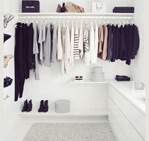 an organized closet with clothes and shoes