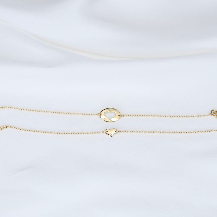 Mother Daughter bracelet set Mother's bracelet: - 14K gold charm is about 14mm x 10mm. - 14K gold 1.3mm cable chain Daughter's bracelet: - 14K gold heart charm is about 8mm x 6mm. - 14K gold 1.3mm cable chain 14K gold components To see other Mother daughter set click here: https://www.etsy.com/shop/SashJewelry?section_id=12441134&ref=shopsection_leftnav_1 To see more children's jewelry click on the link below. http://www.etsy.com/shop/SashJewelry?section_id=12441132 To see more Sash Jewelry Elegant Heart Bracelet With Charms, Gold 14k Heart Bracelet, Hypoallergenic Yellow Gold Heart Pendant Jewelry, Adjustable Gold Heart Bracelet Fine Jewelry, Gold 14k Gold Bracelets With Heart Charm, Adjustable Gold Luxury Heart Bracelet, Adjustable Gold Heart Bracelet In Fine Jewelry Style, Yellow Gold Bracelet With Heart Charm As Gift, Elegant Heart Pendant Charm Bracelet For Gift