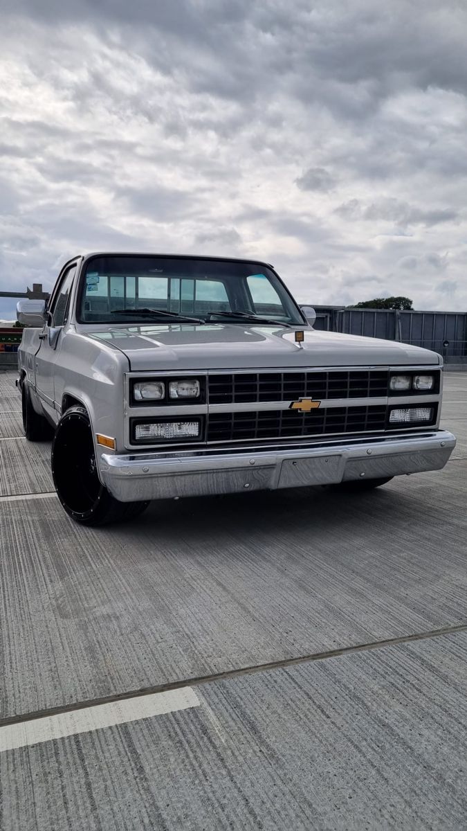 a silver truck parked on top of a parking lot