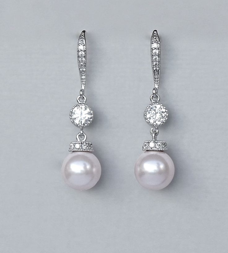 "Ivory white pearl drop bridal earrings are made with a beautiful Swarovski pearl with a crystal studded white gold cap and completed with a sparkling channel set cubic zircon and zircon studded french hook ear wire. A perfect little twist on an elegant classic! Select your color from our extensive pearl collection. Measurement: L- approx 1 3/4\" (4cm) Post is nickel free. 💞 All our jewelry is presented in velvet pouches and high quality elegant, padded boxes ready for gifting 💝 ♥♥Models own e Luxury Pink Pearl Earrings, Cheap Pink Pearl Drop Earrings, Cheap Pink Pearl Earrings As Gift, Cheap Pink Pearl Earrings For Gift, Luxury Pink Round Pearl Earrings, Luxury Pink Pearl Earrings For Formal Occasions, Cheap Pink Pearl Earrings, Affordable Pink Elegant Pearl Earrings, Bridal Drop Earrings