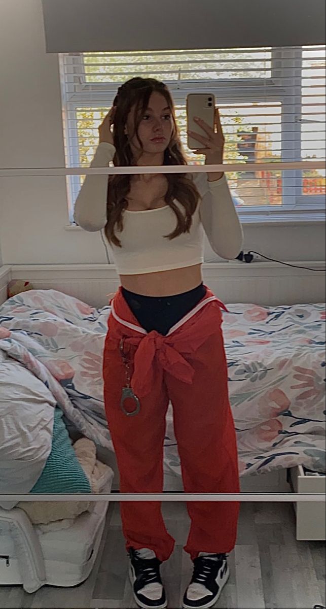 a woman taking a selfie in her bedroom