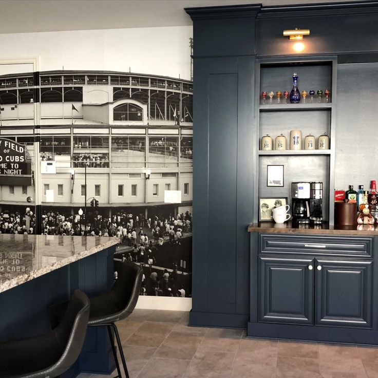 a baseball stadium themed wallpaper in a bar with chairs and bottles on the counter