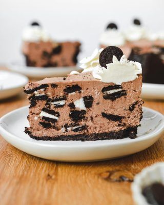 a piece of chocolate cheesecake with oreo cookies and cream frosting on top