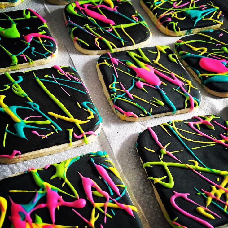 decorated cookies with icing and sprinkles on a table