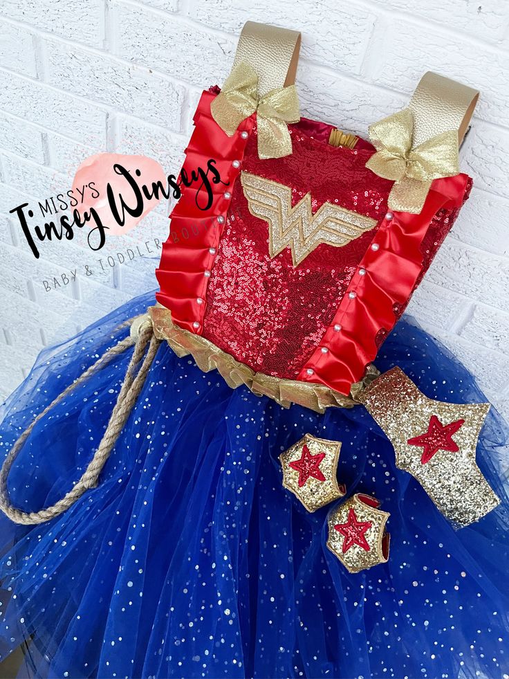 This set comes with the dress, cuffs, and headpiece ! The bodice is made with red sequin and lined with red satin , embroidered with the Wonder Woman logo, with detailed ribbon and pearls ! The skirt is made with tulle and and underlying skirt to hide from seeing underneath ! A rope is attached as well for the realistic detail! Thank you for shopping MTW! Please reach out if you have any questions ! Red Princess Costume Dress, Red Tulle Dress For Fancy Dress Occasions, Red Princess Costume For Costume Party, Fitted Red Princess Costume, Red Fitted Wedding Costume, Red Princess Costume For Fancy Dress, Costume Dresses With Sequins For Party Season, Costume Sequin Dresses For Party Season, Tulle Costume Dress For Carnival