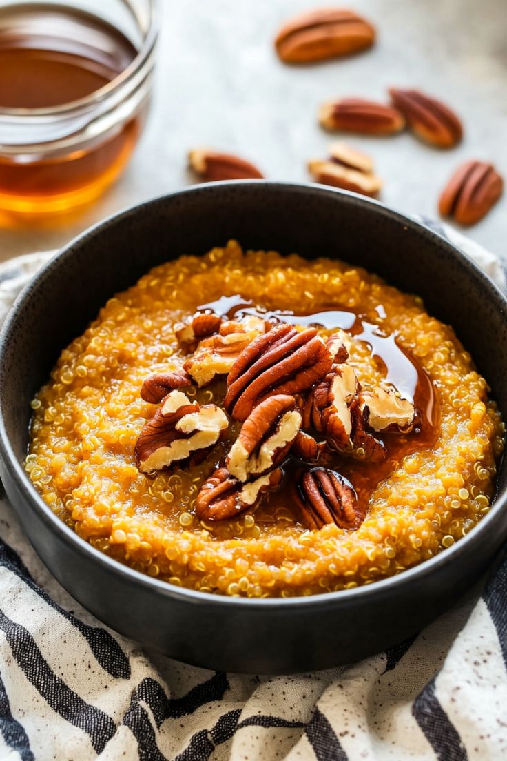 a bowl filled with oatmeal topped with pecans