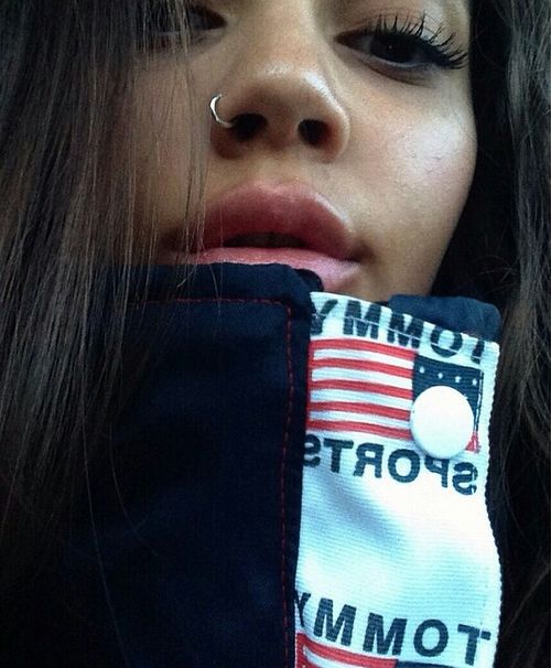 a close up of a person with long hair and an american flag scarf around her neck