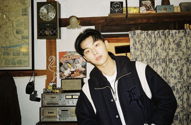 a young man standing in front of a radio