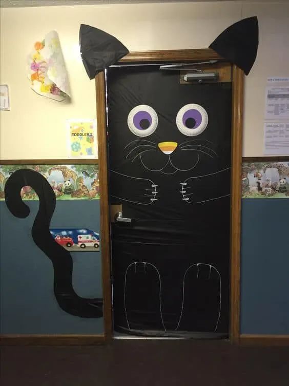 a door decorated to look like a black cat