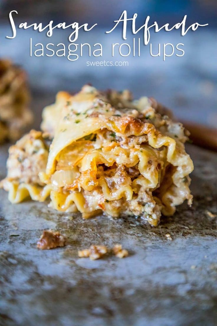 a close up of food on a plate with words above it that reads sausage alfredo lasagna rolls