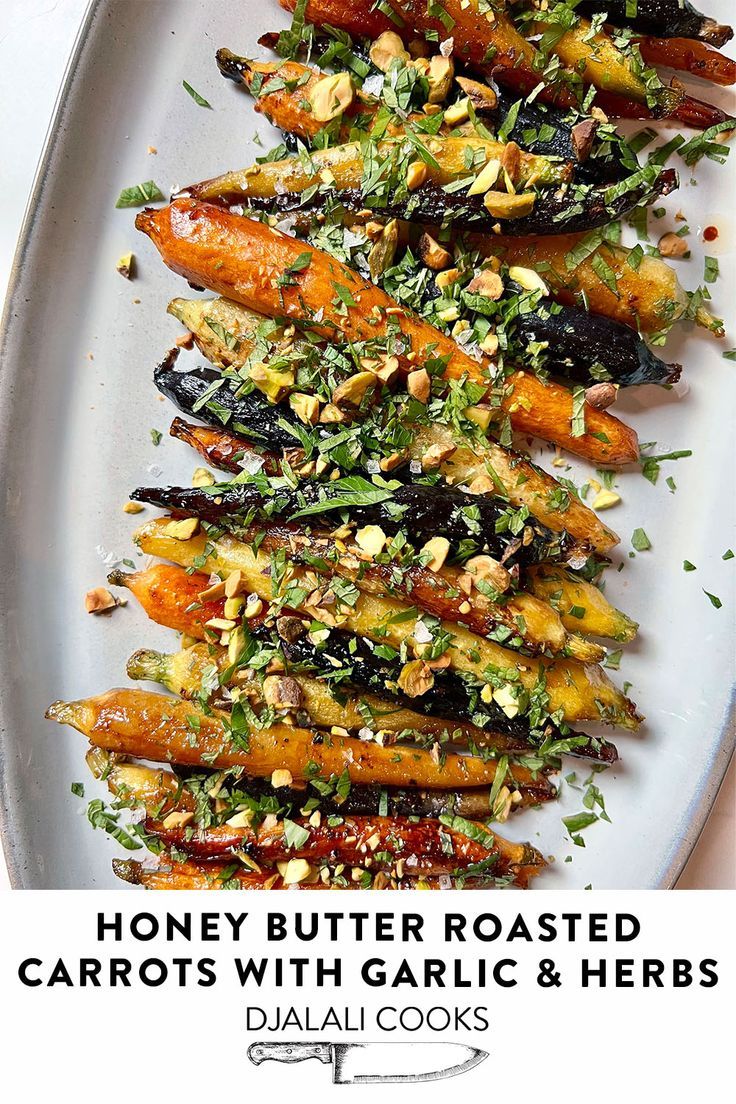 roasted carrots with garlic and herbs on a white plate