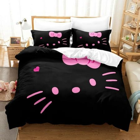 a black bed with pink polka dots and a cat face on the comforter cover