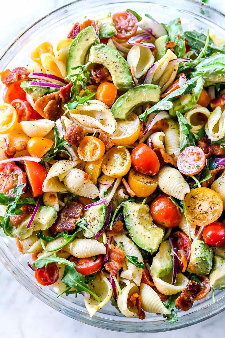 a bowl filled with pasta salad on top of a table