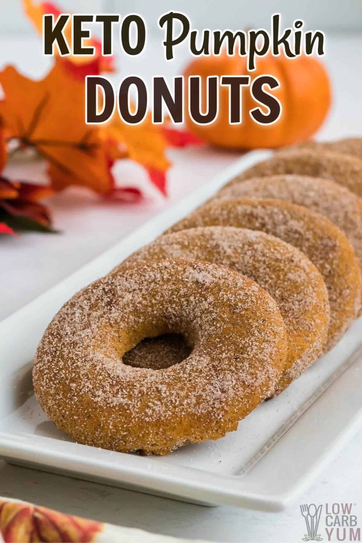 three donuts on a white plate with the words keto pumpkin doughnuts