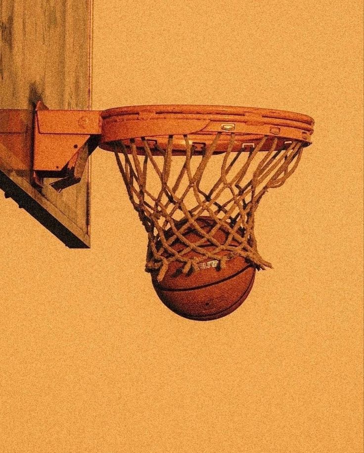 an old basketball going through the rim of a hoop with it's net still attached