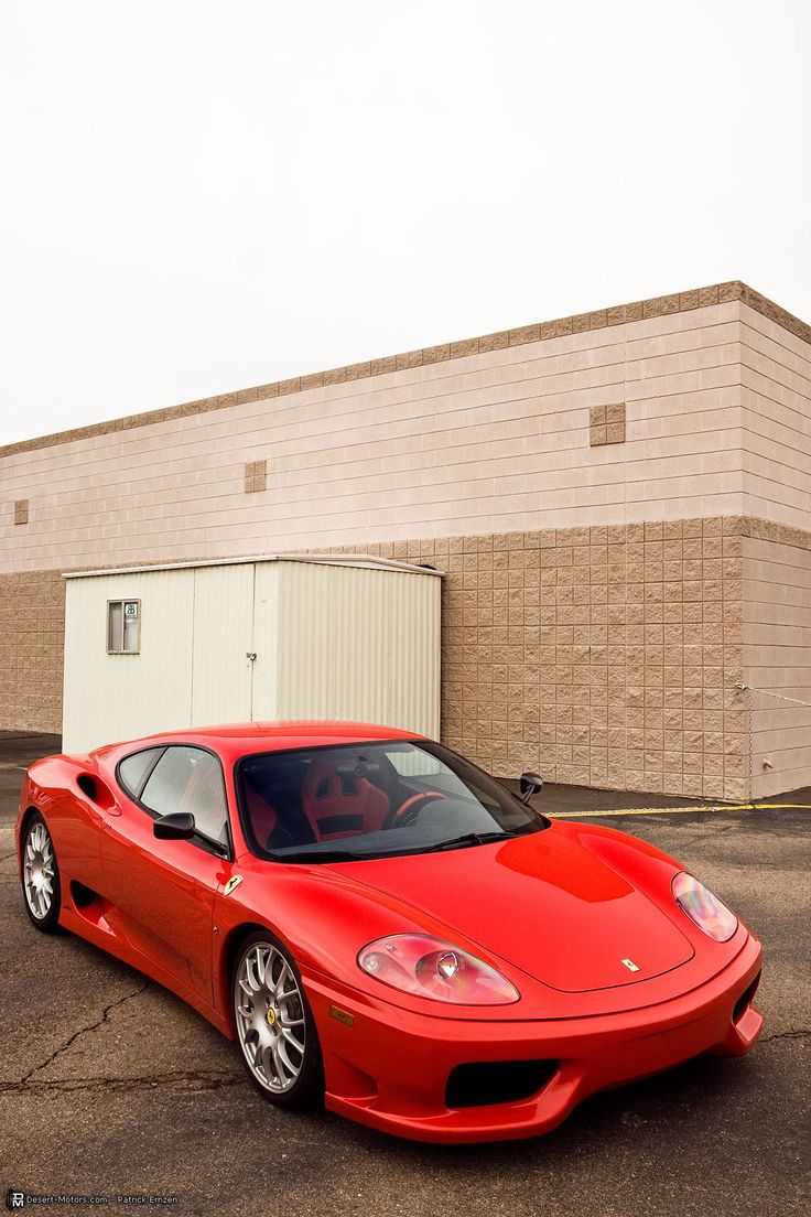 a red sports car parked in front of a building