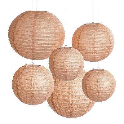 four round paper lanterns hanging from the ceiling