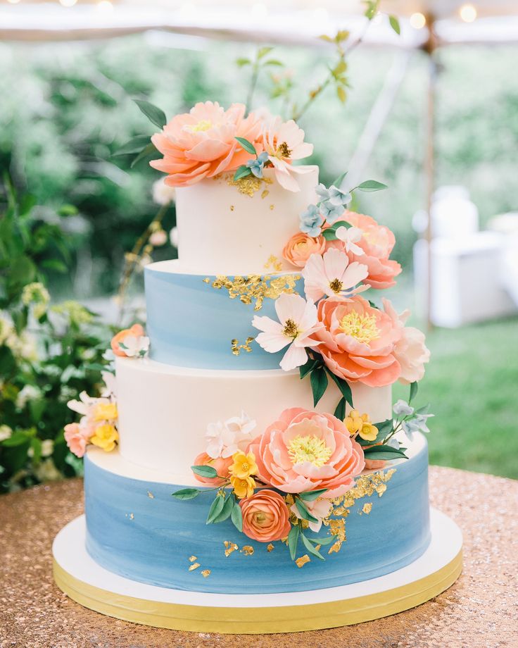 a three tiered cake with flowers on it