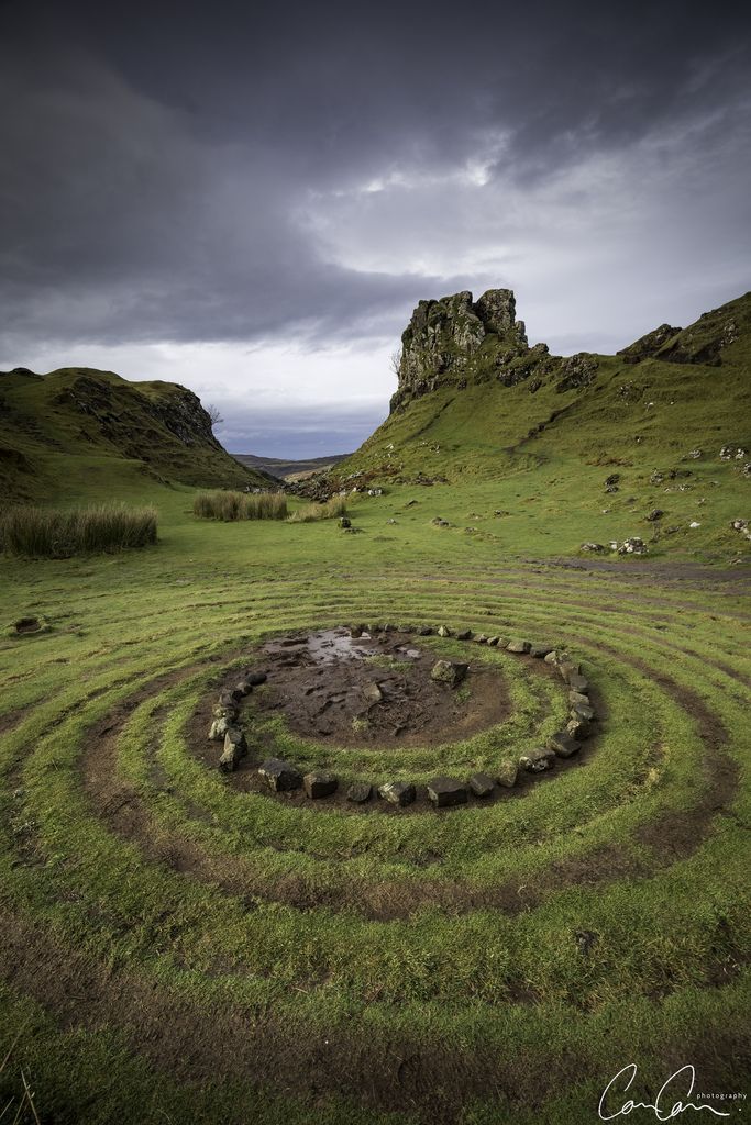 a grassy field with a circular design in the middle