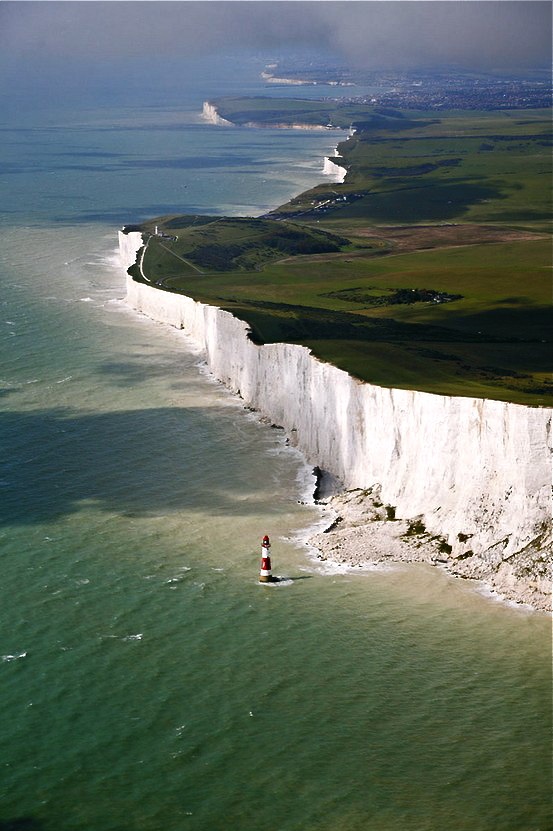 an aerial view of the white cliffs and lighthouses at seven sisters beach in england