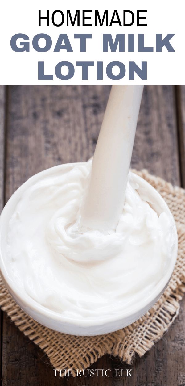 homemade goat milk lotion in a white bowl on a wooden table with text overlay that reads homemade goat milk lotion