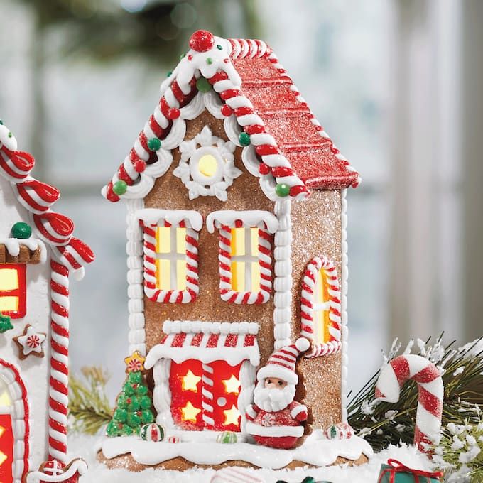 a gingerbread house decorated with candy canes and lights