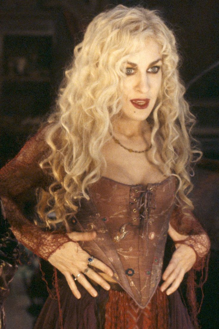 a woman with blonde hair wearing a corset and holding her hands on her hips