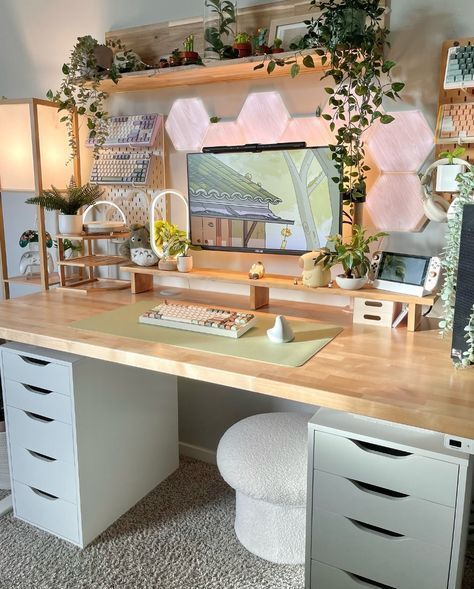 a desk with two drawers and a computer monitor sitting on top of it next to some plants