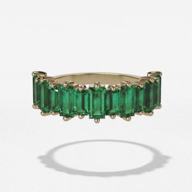 This is a stunning piece, perfect for adding style and flair to any look. Made using baguettes shaped emerald gemstones, it has a unique yet timeless aesthetic that will never go out of style. The halfway band design means this ring will wear comfortably and completely complement your existing jewelry collection. Whether it's worn on its own or stacked with other rings, this piece is sure to give you unforgettable color. The five millimeter width makes the ring just wide enough to be noticed wit Half Eternity Baguette Cut Emerald Jewelry, Baguette Cut Emerald Half Eternity Jewelry, Elegant Emerald Baguette Cut Ring, Luxury 14k Gold Emerald Ring With Baguette Diamonds, Elegant Emerald Ring With Baguette Diamonds, Baguette Cut Emerald Ring For May Birthstone, Luxury Emerald Half Eternity Jewelry, Emerald Cut Eternity Band, Baguette Wedding Band