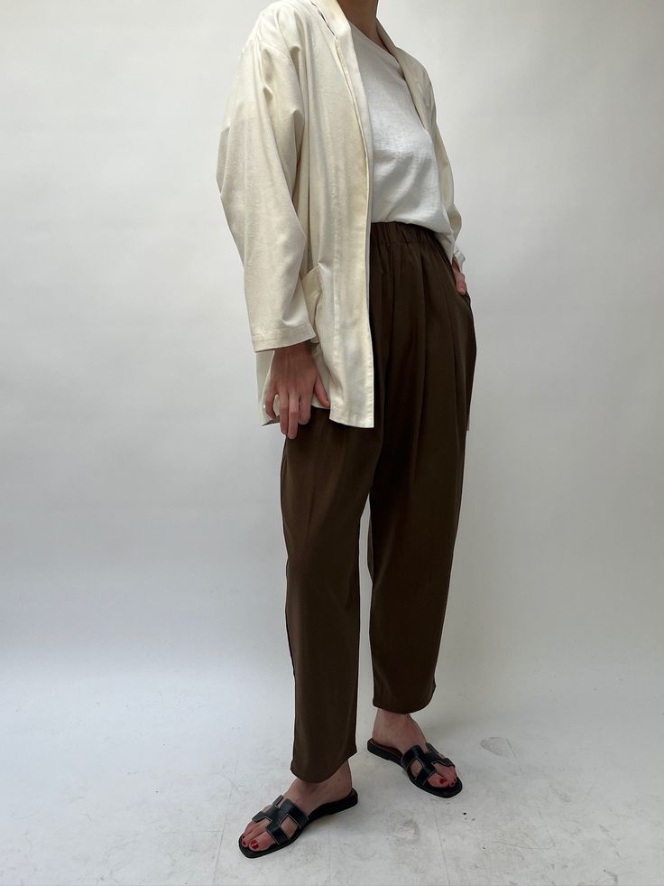 The versatile Lena Pant, created in our durable and cozy silk canvas, is an essential addition to any wardrobe. Boasting a comfortable elastic waist, attractive front pleats, convenient side pockets, and a stylish cropped leg, the Lena Pant is perfect for any occasion. Our highly sought-after Lena Pant is now even more luxurious with its new design in pure silk, maintaining the same trusted quality and texture. 100% Silk Made in USA Available in 26" inseam and 29" ( Full Length ) *If you’re in-b Versatile Tapered Leg Harem Pants For Loungewear, Spring Workwear Parachute Pants With Elastic Waistband, Chic Parachute Pants With Elastic Waistband And Tapered Leg, Spring Parachute Pants With Elastic Waistband For Work, Relaxed Fit Bottoms With Pleated Waist For Daywear, Relaxed Fit High-waisted Viscose Pants, High-waisted Relaxed Fit Viscose Pants, Versatile Relaxed Fit Viscose Pants, Beige Parachute Pants With Elastic Waistband For Work