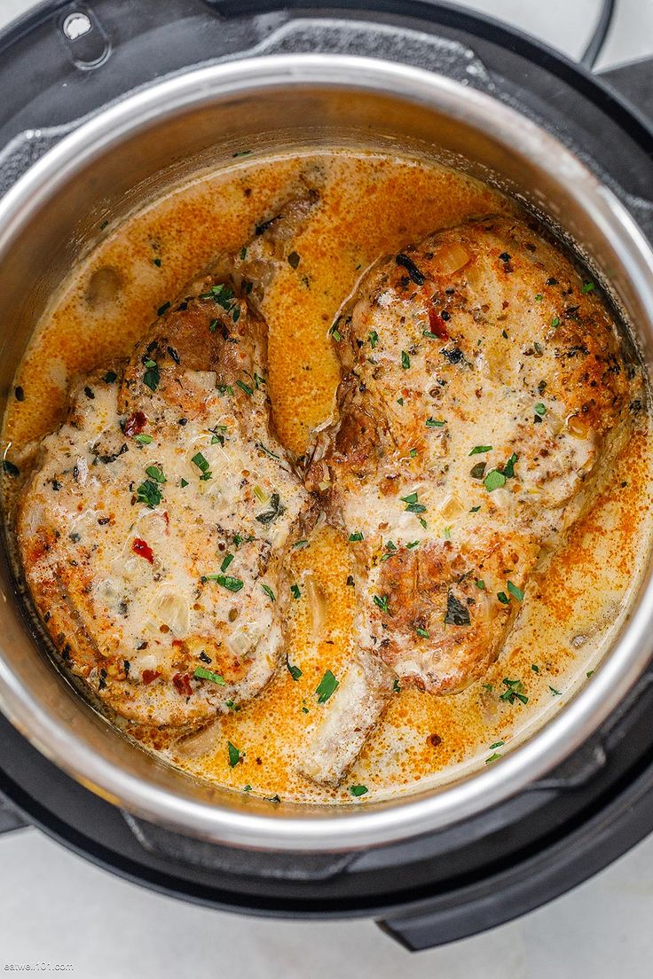 the meat is being cooked in the crockpot on the stove top with some parsley