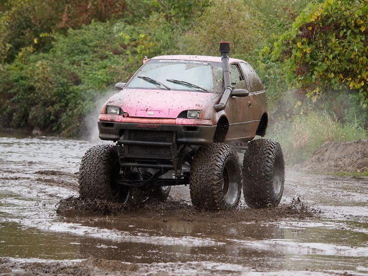 a truck is driving through the water with its wheels in the air and it's front tire out