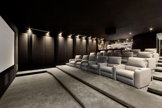 an empty movie theater with white seats