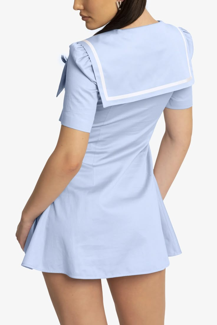 This is a dreamy Sailor dress made in cotton poplin, light blue with a white border and a cute little white ribbon tied in front. Fits true to size. The model is wearing size 40. Sailor Uniform Aesthetic, Cute Sailor Outfit, Light Blue Princess Dress, Light Blue Outfits, Pastel Blue Outfit, Austin Powers Costume, Beach Coquette, Blue Princess Dress, Sailor Outfit