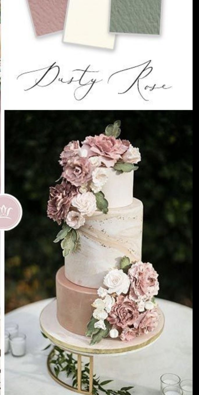 the wedding cake is decorated with flowers and greenery on it's side, along with matching napkins