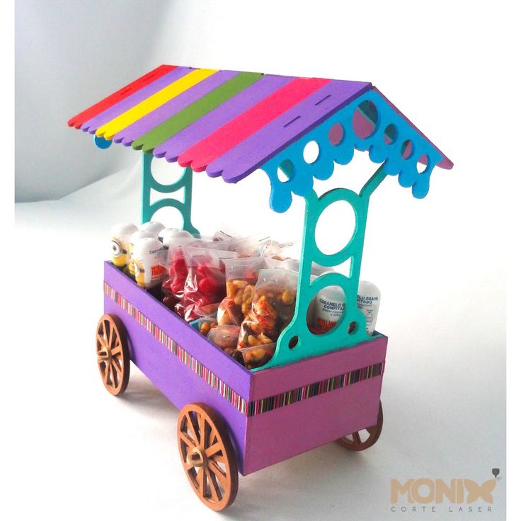 a colorful cart filled with candy and candies under a rainbow awning on a white background