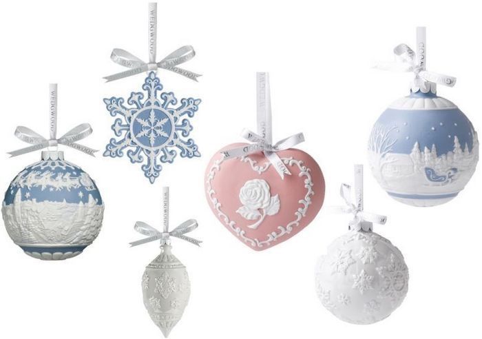 four ornaments are hanging from the ceiling in different colors and designs, including snowflakes