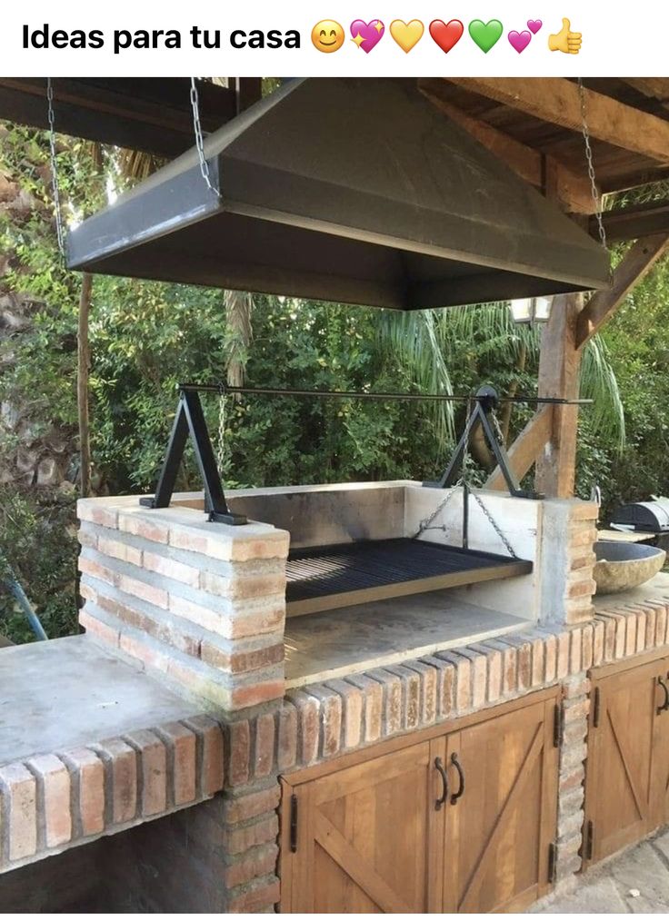 an outdoor kitchen with a brick oven and grill