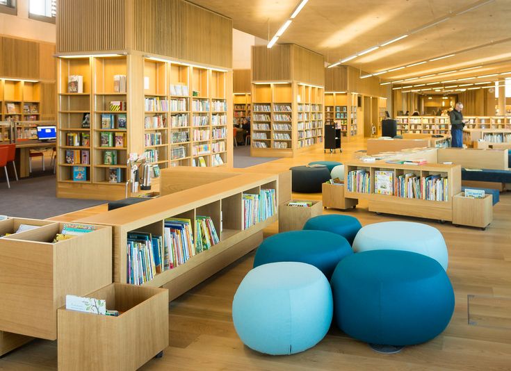 an empty library with blue stools and bookshelves