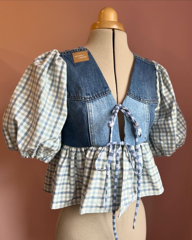 a mannequin wearing a blue and white checkered top with ruffles