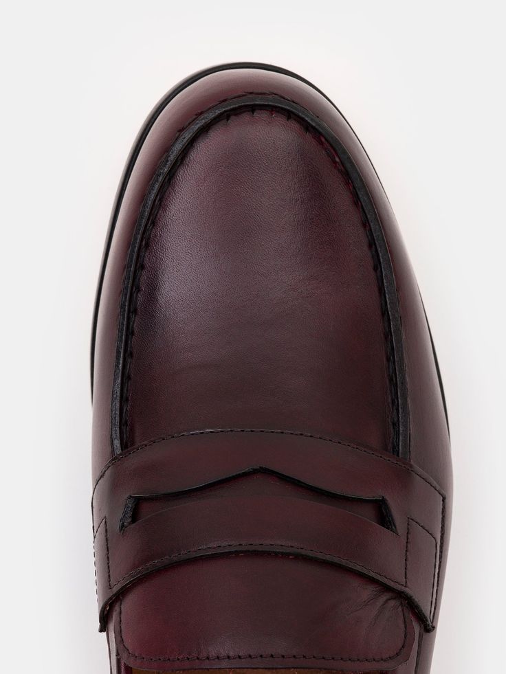 Color: bordeaux Cow leather with natural finish Penny front Leather insoles Rubber and leather soles Hand-stitched detailing Classic Burgundy Loafers For Office, Classic Burgundy Loafers With Rubber Sole, Burgundy Leather Sole Loafers For Workwear, Burgundy Slip-on Loafers For Business, Classic Burgundy Leather Shoes With Rubber Sole, Burgundy Slip-on Formal Loafers, Burgundy Slip-on Loafers For Formal Occasions, Burgundy Slip-on Dress Shoes For Business, Classic Burgundy Loafers For Formal Occasions