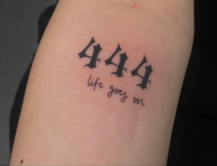 a tattoo with the words'4 / 4 life goes on'written in cursive font