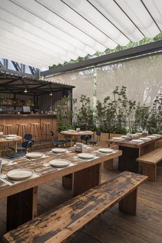 an outdoor dining area with wooden tables and benches