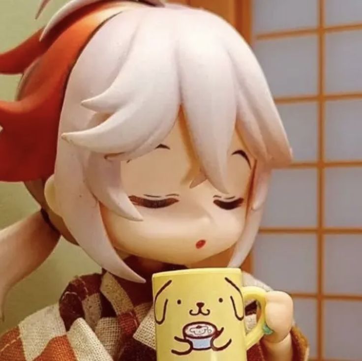 a close up of a doll holding a cup