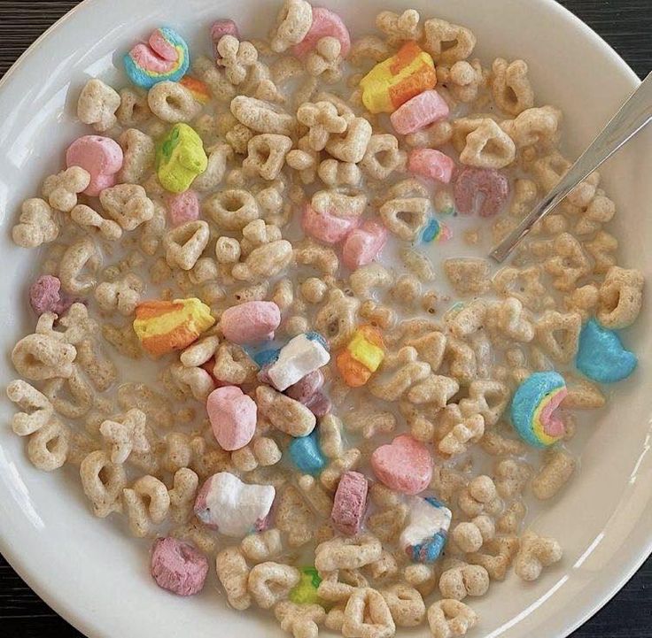 a white bowl filled with cereal and marshmallows