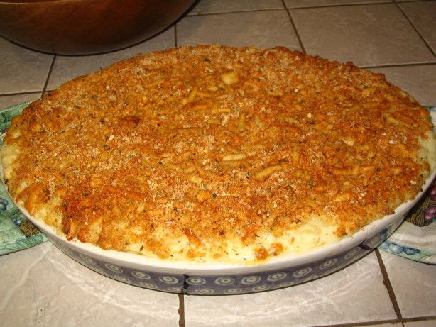 a casserole dish is sitting on a table with a blue and white plate