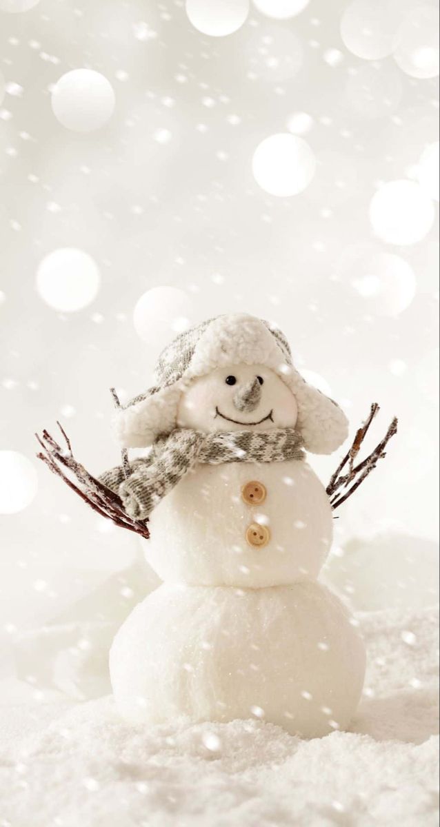 a snowman wearing a hat and scarf on top of it's head in the snow